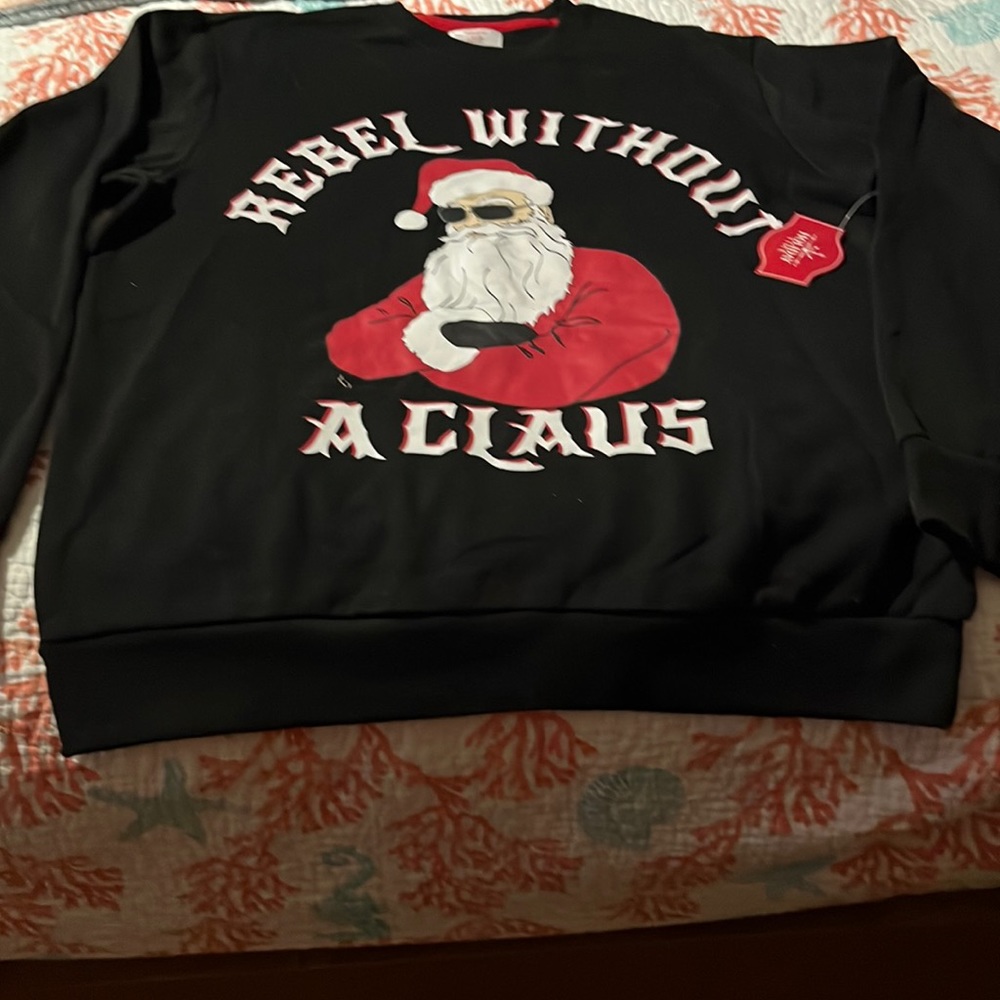 Holiday Sweat Shirt. New with tags. Solid black back side.
